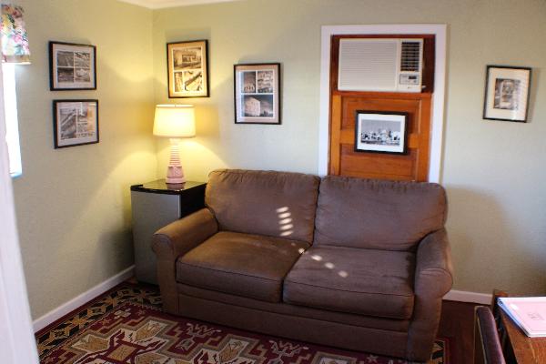 The sofa in the parlor is a comfortable place to relax, read, or watch TV. The suite also features an in-room refrigerator for your convenience. 