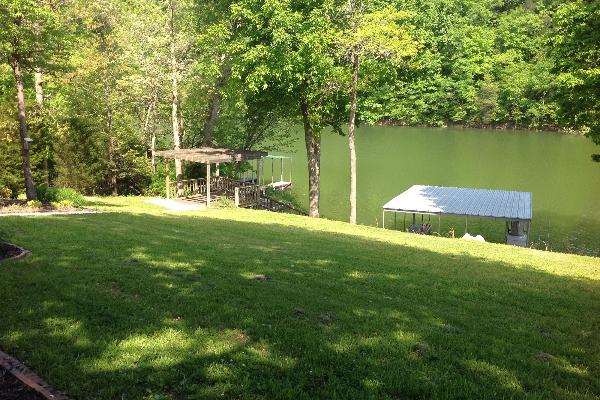 Backyard lake side covered dock with swim platform