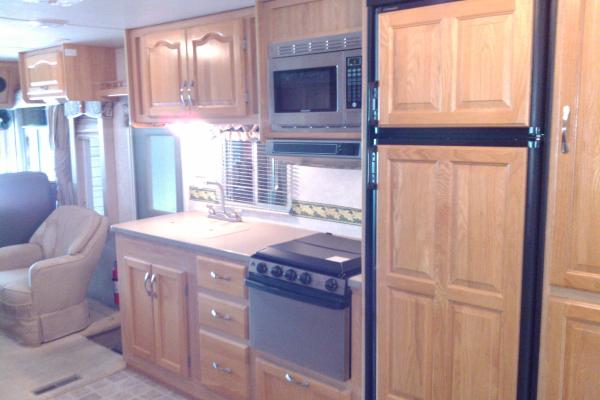 Full Kitchen with stainless steel stove/oven and microwave, large double door fridge/freezer