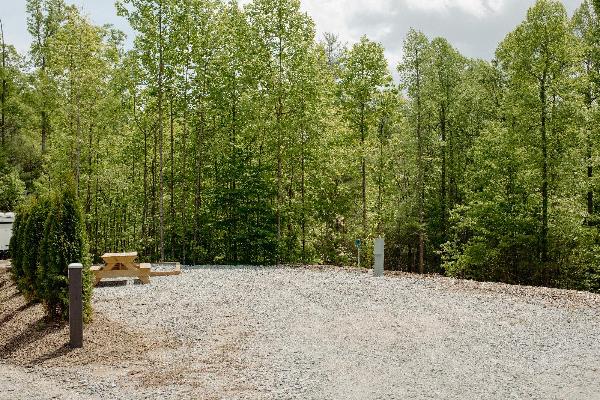 Site #273- 52'L x 28'W, back-in, 50/30 amp, FHU, table and fire ring w/ cooking grate. Next to Bath house! (Waiting on trees to be planted).