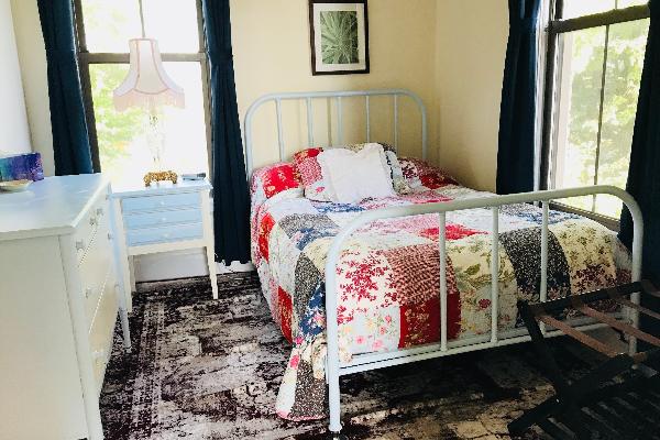 Enjoy the soft rug beneath your feet, the antique furnishings and sunrise views from this second-story room.