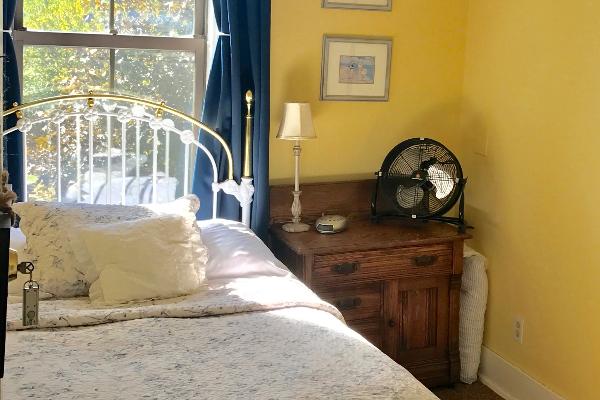 Cassie Room, bright and cheery and conveniently located across from the bathroom. Enjoy our central AC, room-darkening curtains and oh so romantic bedding.