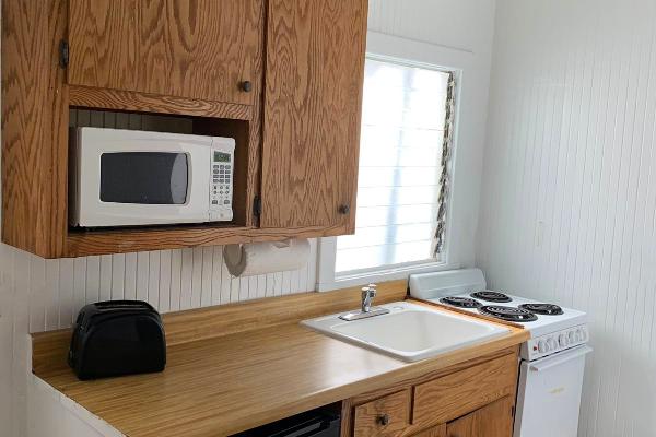 Kitchen with microwave, refrigerator, oven, and stove.
