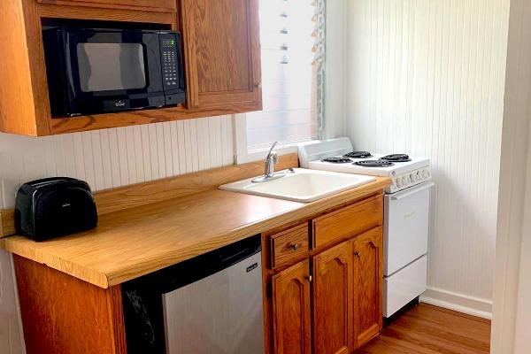 Kitchen with microwave, refrigerator, oven & stove.