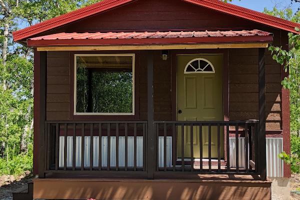 Enjoy relaxing on the shaded front porch of Snow Moon Cabin.
