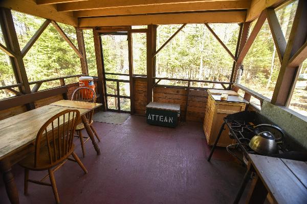 Enjoy the screened in porch that features a refrigerator (not pictured), two burner cookstove, and pots/pans,dishes.